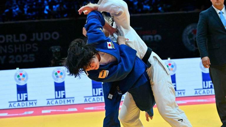 Japan's Shiho Tanaka (blue) competes against Croatia's Lara Cvjetko during the women's -70kg fianl bout of the Judo World Championships at the Papp Laszlo Arena in Budapest, Hungary, on June 17, 2025. - AFPPIX